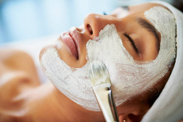 Relaxing facial treatment: Woman receiving a soothing facial mask in a spa setting